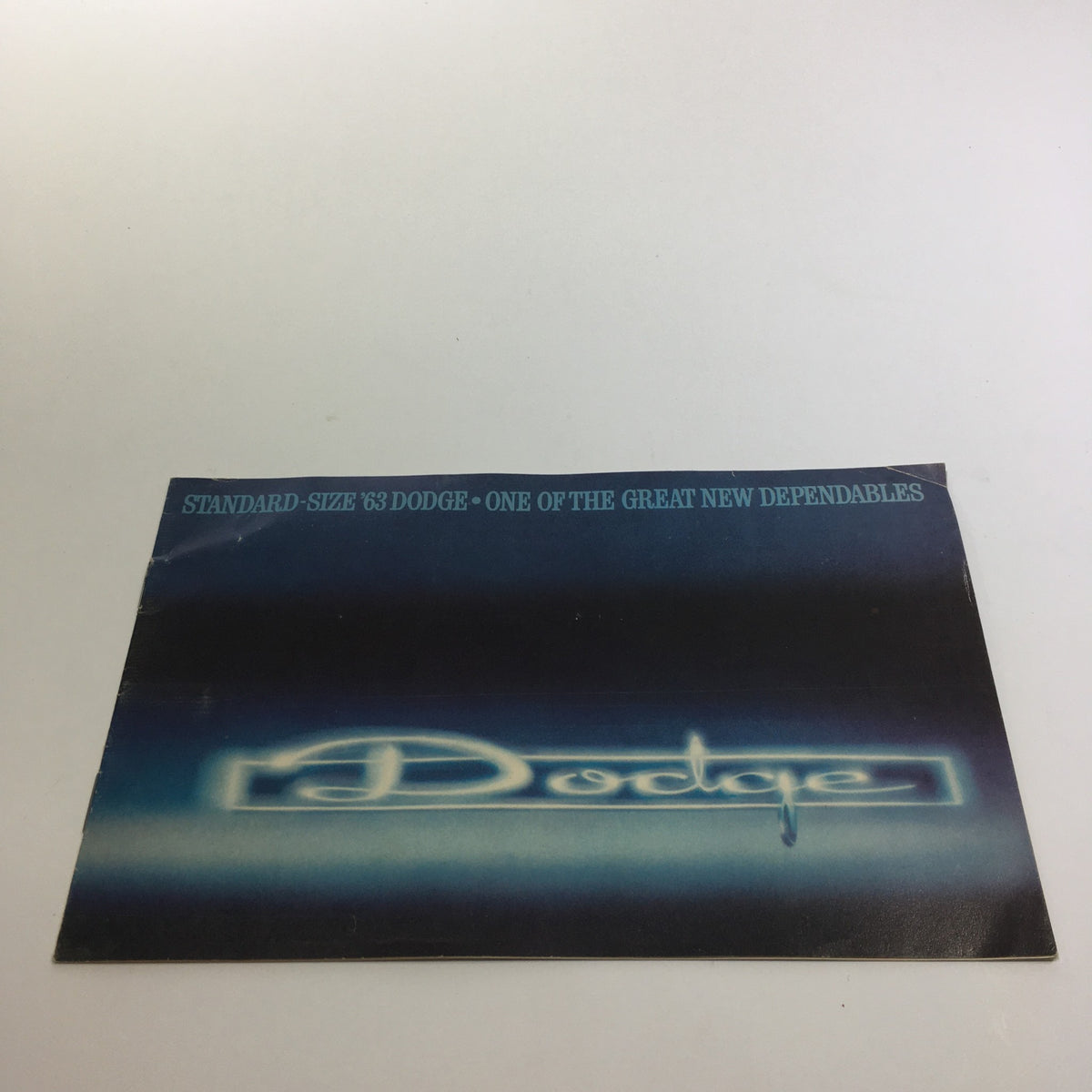 Cover of the 1963 Dodge - Compact Dodge Dart - Standard Sz Dodge - Big Custom 880 Car Catalog showcasing the Dodge logo against a blue background.