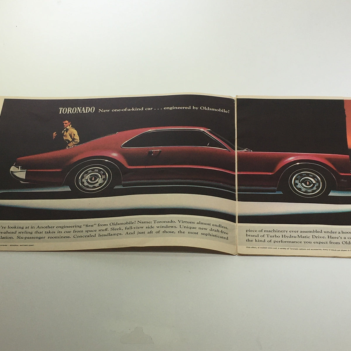 Inside view of the 1966 Oldsmobile Sports Model Tornado-Starfire brochure, showcasing the unique design of the Toronado model with a sleek silhouette and engineering details.