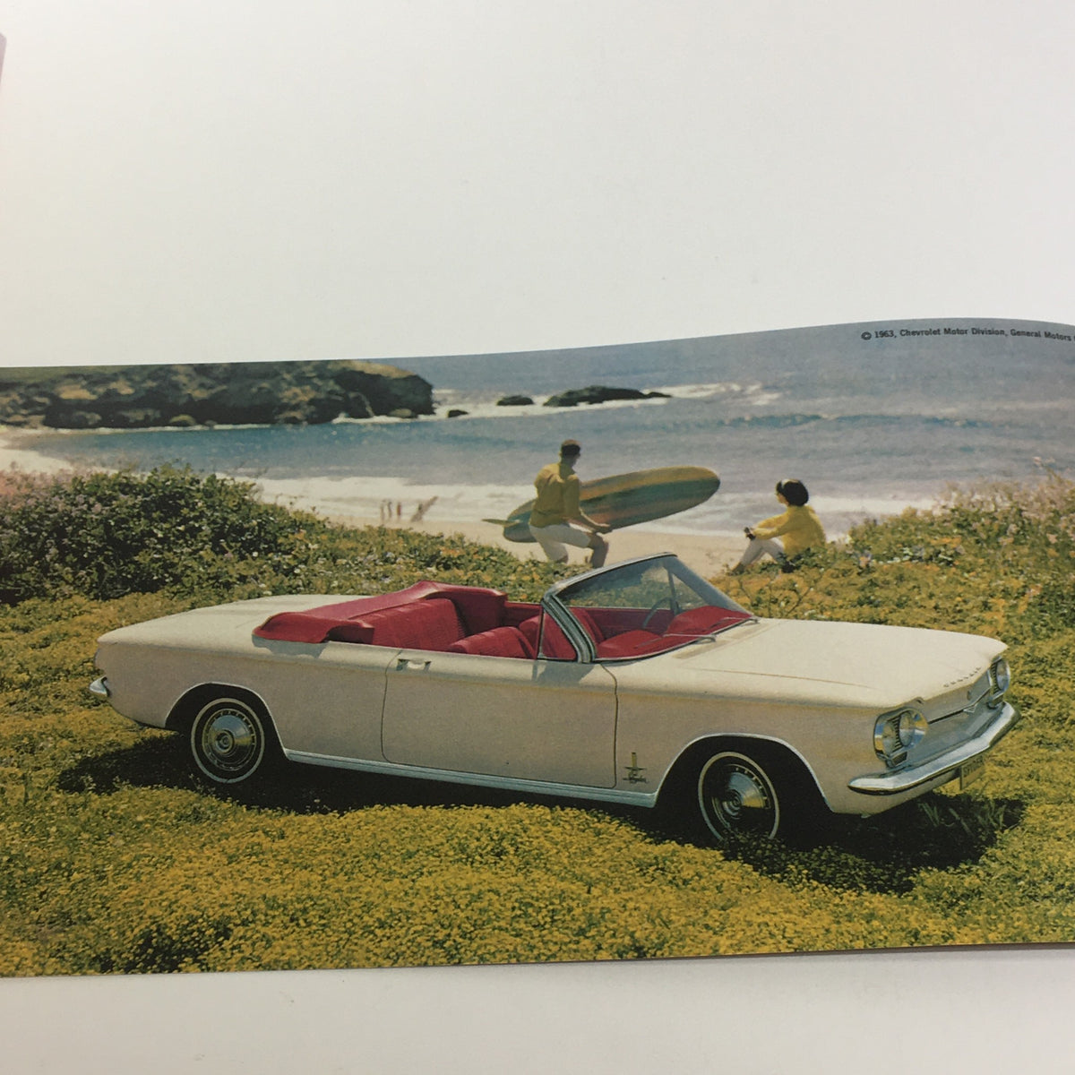 1964 Corvair by Chevrolet Turbo-Supercharged V-8 Engine 3-Speed Tran Car Catalog showcasing a white convertible Corvair against a scenic beach backdrop with surfers in the background.