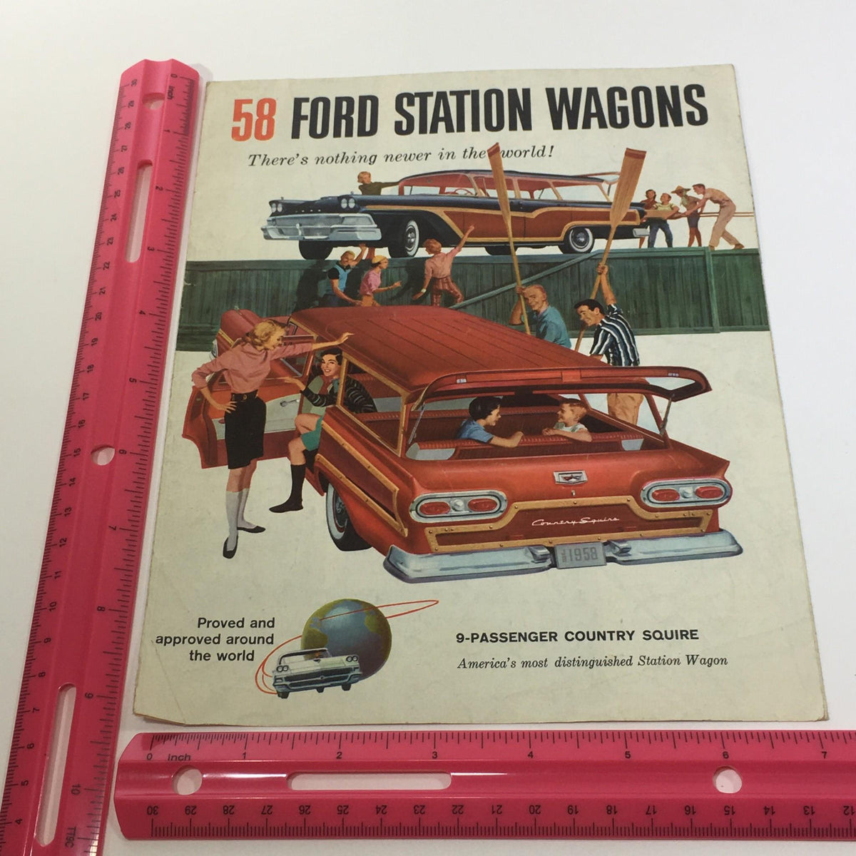 Close-up of the cover of the 1958 Ford Station Wagons Interceptor 352 Special V8 Engines Car Catalog with a ruler for size reference and showcasing the 9-passenger Country Squire.