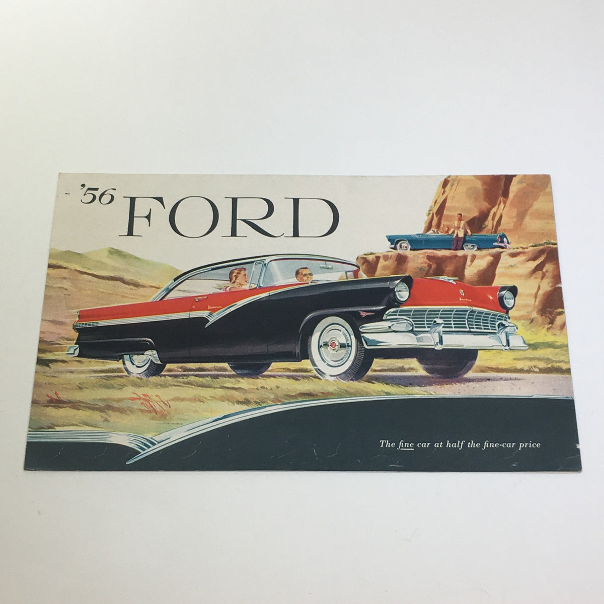 Vintage advertisement featuring a 1956 Ford Thunderbird in a scenic landscape, highlighted in the 1956 Ford Thunderbird Y-8 Power Double-Swivel Lifeguard Mirror Car Catalog. The illustration shows two couples enjoying a drive in classic cars with the tagline, 'The fine car at half the fine-car price.'