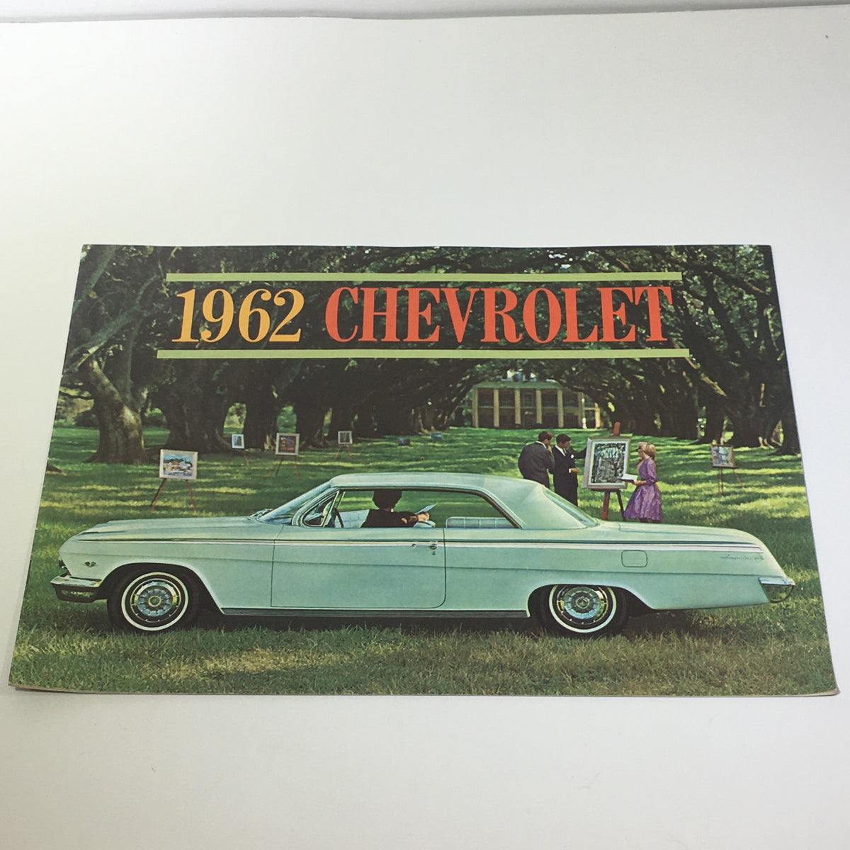 1962 Chevrolet Impala Super Sport Coupe Turbo-Fire 283 V-8 Engine Car Catalog cover featuring a light green Chevrolet Impala parked in a scenic setting.