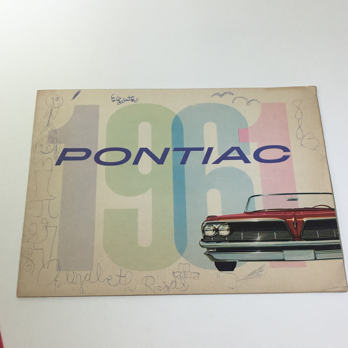 1961 Pontiac Catalina Sport catalog cover featuring the iconic Pontiac logo and a classic car illustration, showcasing vintage automotive design.