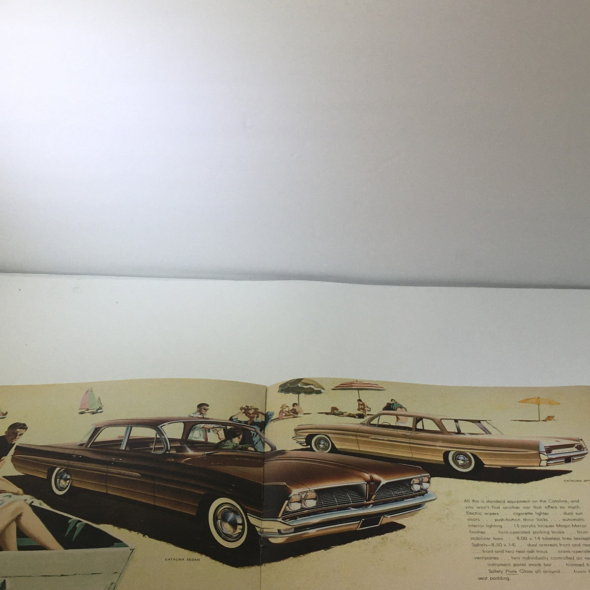 Open view of the 1961 Pontiac Catalina Sport catalog displaying illustrations of classic cars, perfect for automotive enthusiasts and collectors.