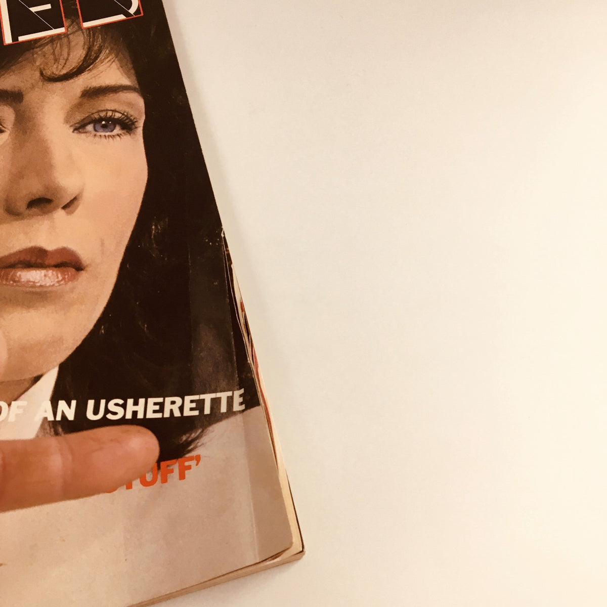 Close-up view of the July 1983 The Movies magazine cover highlighting Lily Tomlin's memoirs on usherettes, with artistic design elements from the premiere issue.