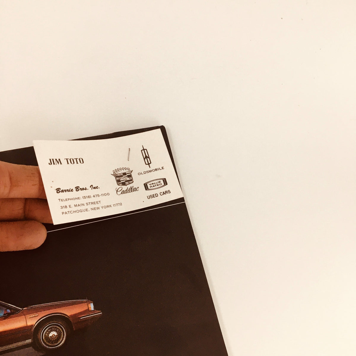 Close-up of a business card for Jim Toto, associated with the 1983 Oldsmobile Cutlass Ciera, Supreme & Cruiser Feature Car Brochure Catalog.