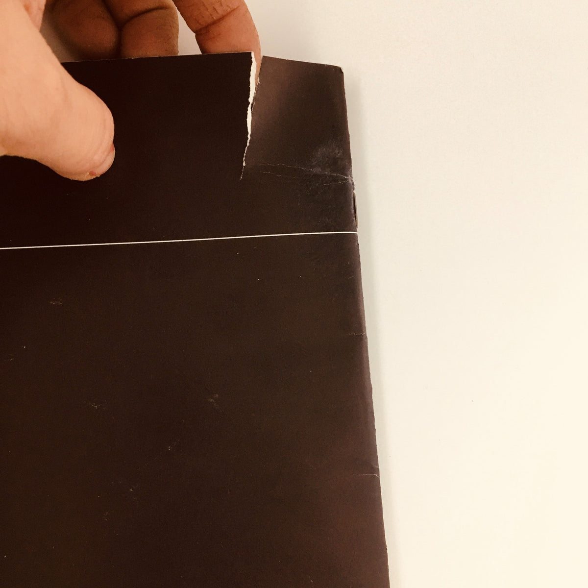 1983 Oldsmobile Cutlass Ciera, Supreme & Cruiser Feature Car Brochure Catalog showing the edge of the brochure with a visible rip, indicating minor wear but preserving its collectible nature.