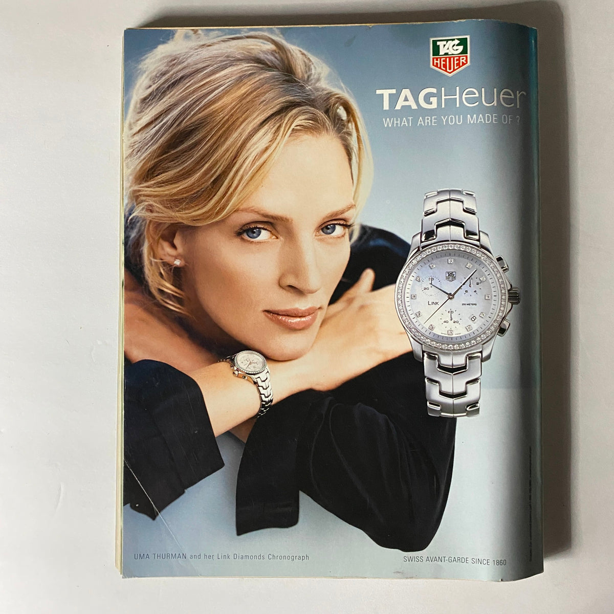W Magazine November 2005 advertisement for TAG Heuer showcasing Uma Thurman with a stylish watch, featuring the tagline 'What are you made of?'.