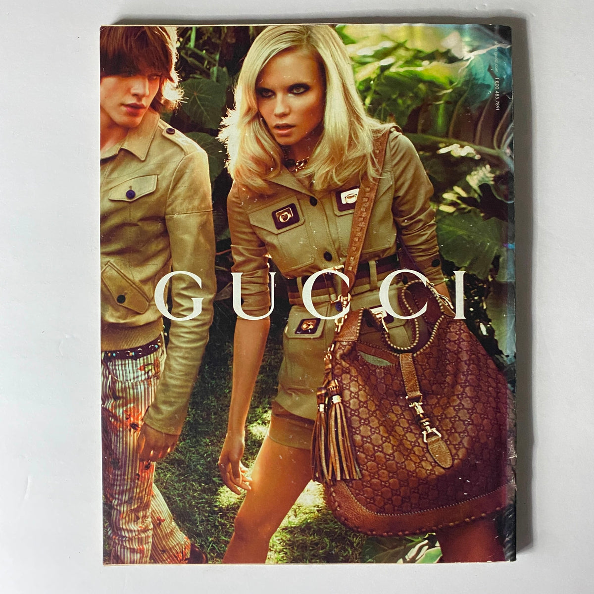 Gucci advertisement featured in W Magazine April 2009, showcasing high fashion aesthetics and luxury items, complementing the iconic cover of Drew Barrymore.