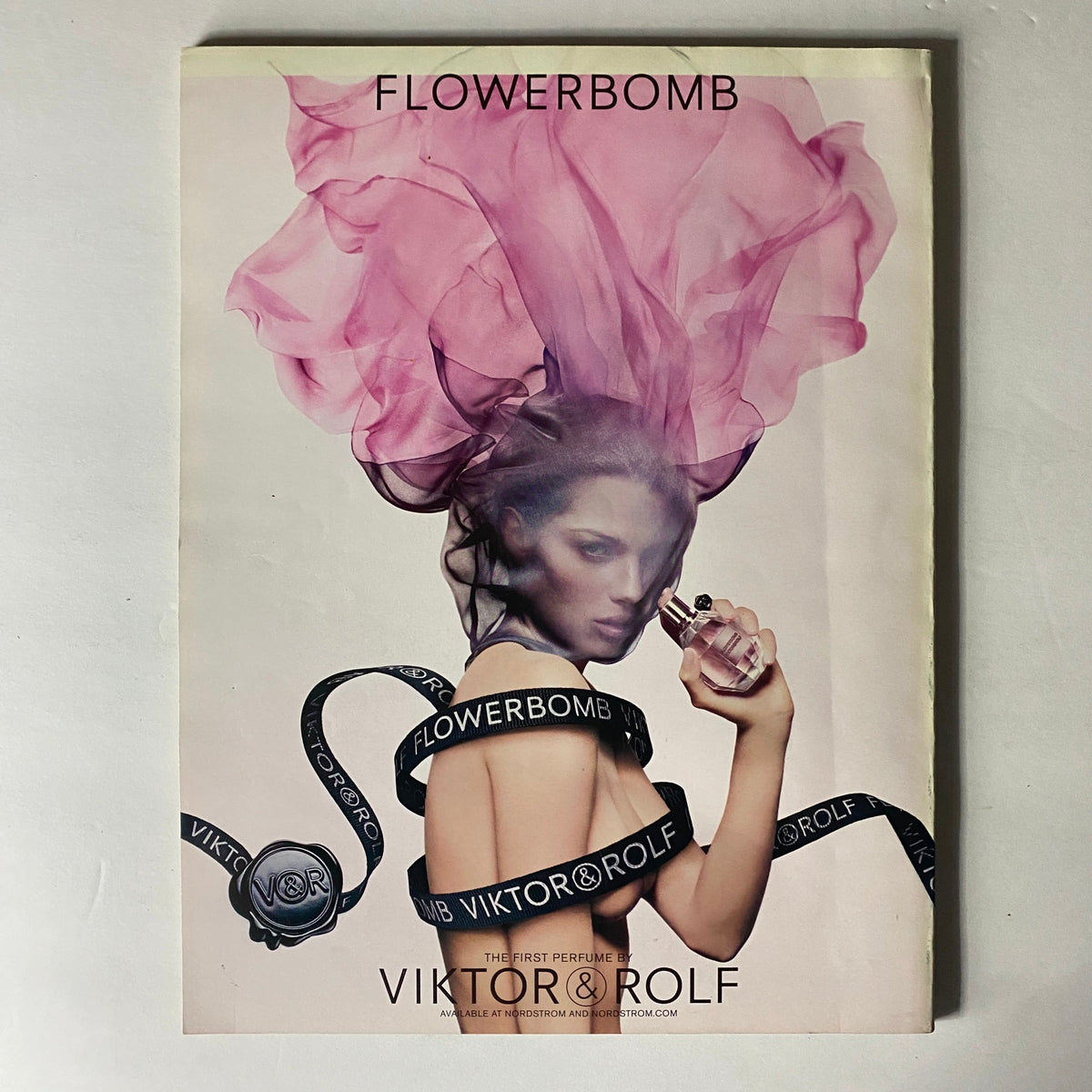 W Magazine May 2009 advertisement featuring Viktor & Rolf's Flowerbomb fragrance, illustrating a stunning model with flowing hair.