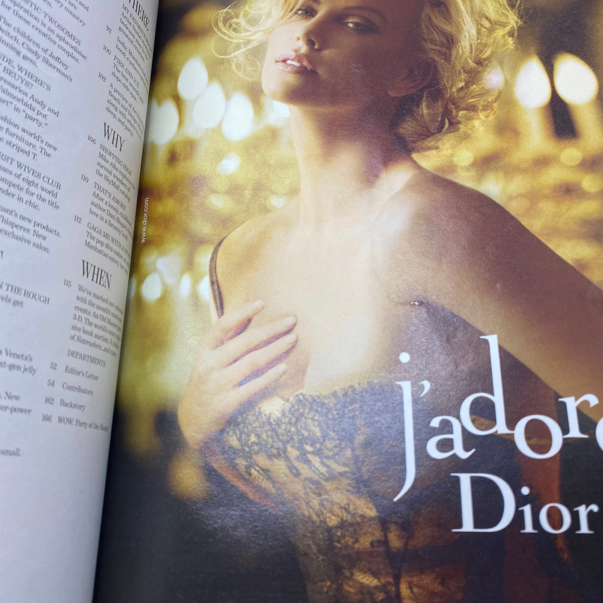 W Magazine December 2010 featuring a stunning fashion spread with Charlize Theron in an elegant dress, showcasing luxury and glamour.