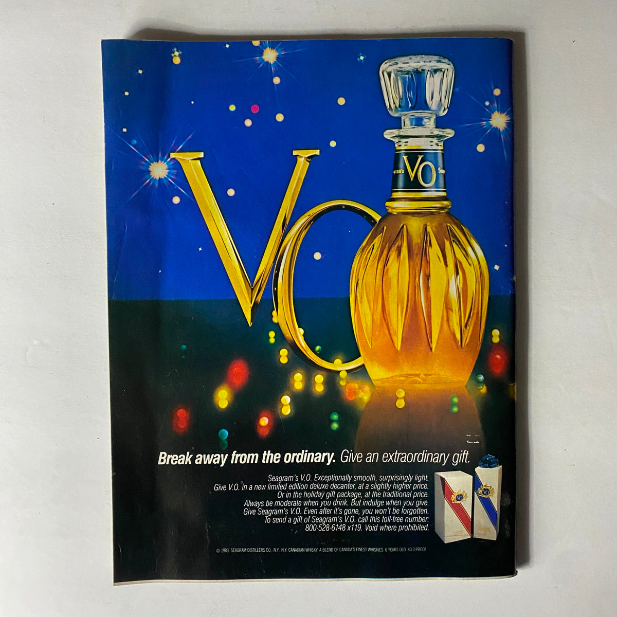 Advertisement page from Sports Illustrated Magazine November 28, 1983, promoting Seagram's V.O. whiskey with a festive design.