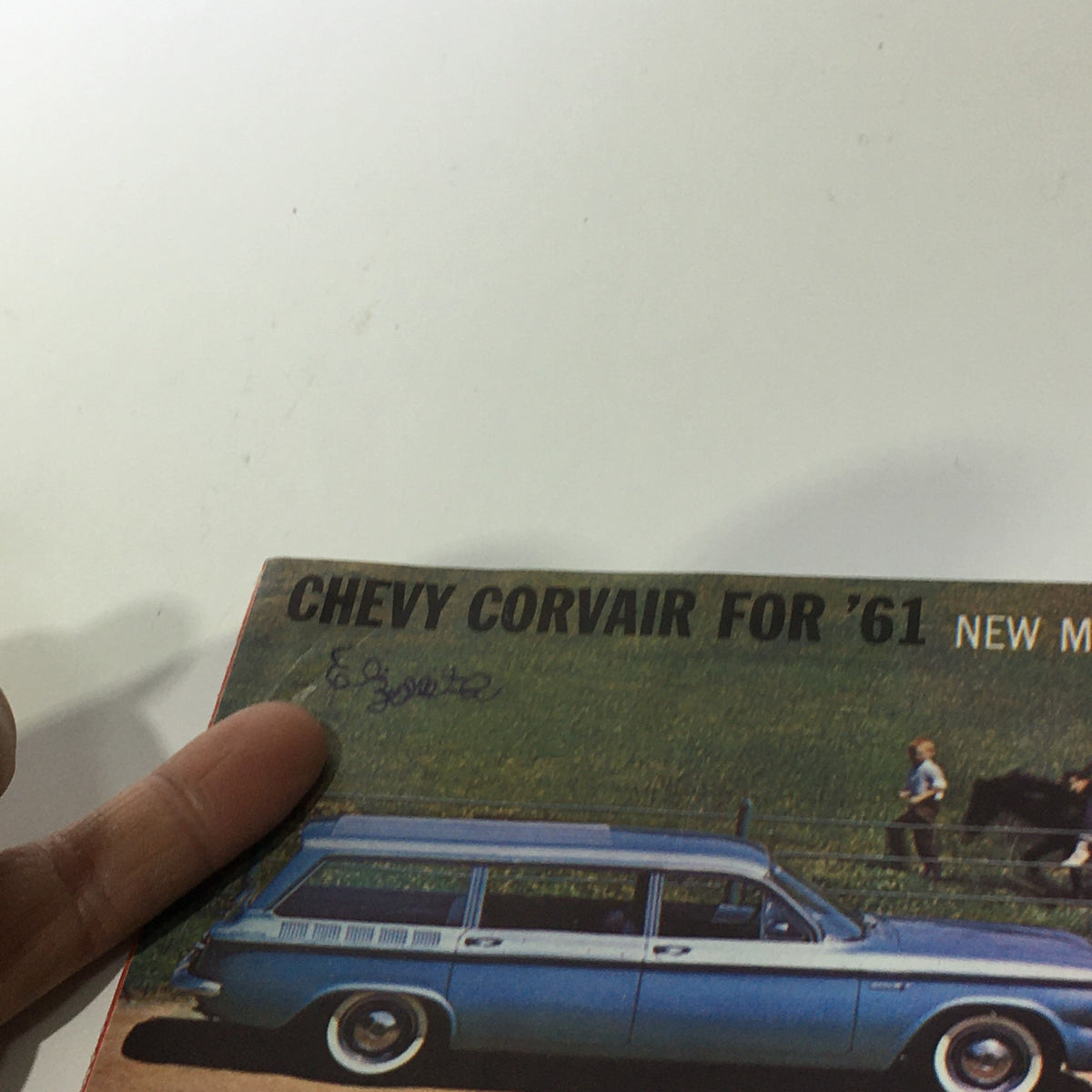 Detailed view of the 1961 Chevy Corvair 500 brochure cover with a blue Chevy Corvair wagon prominently displayed alongside a red Corvair, promoting new models.