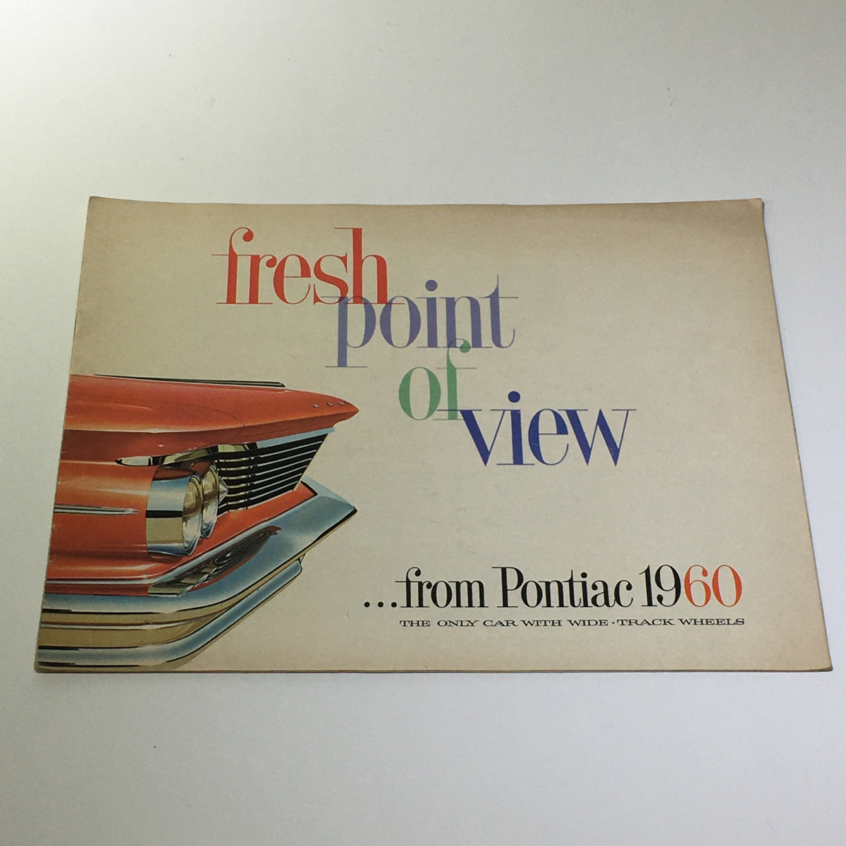 Cover of the 1960 Pontiac Fresh Point of View Catalina brochure featuring a vivid design and the vehicle's chrome front end.