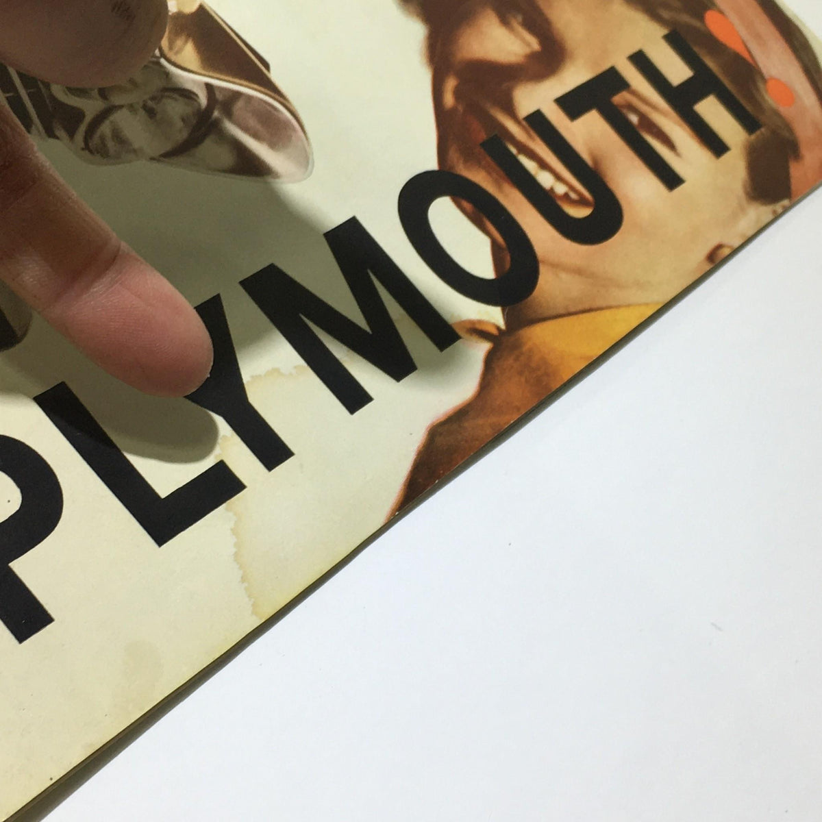 Detail close-up of the 1960 Plymouth Torsion-Aire Ride brochure highlighting the brand name with minor stains.