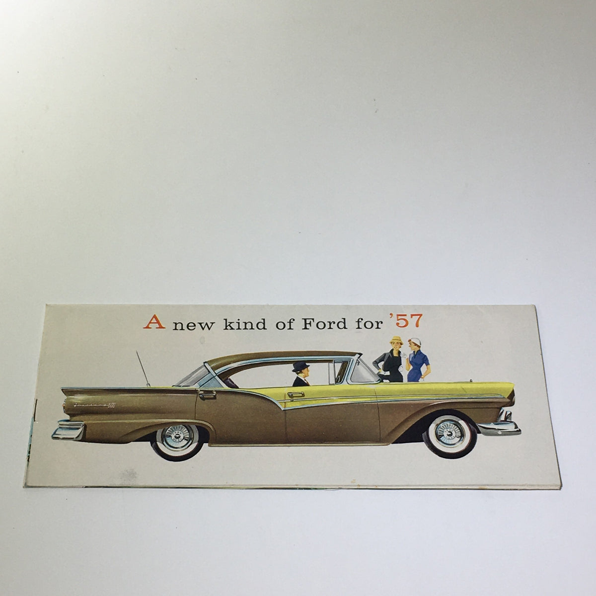 1957 Ford Touch of Tomorrow Master-Guide Power Steering Car Catalog Brochure featuring a side view illustration of a 1957 Ford model with people beside it, showcasing the innovative car design.