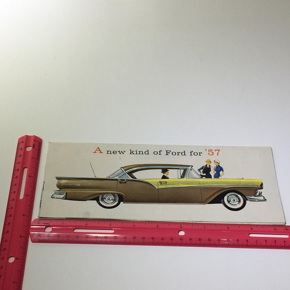 Illustration of a 1957 Ford car with people, from the 1957 Ford Touch of Tomorrow Master-Guide Power Steering Car Catalog Brochure.