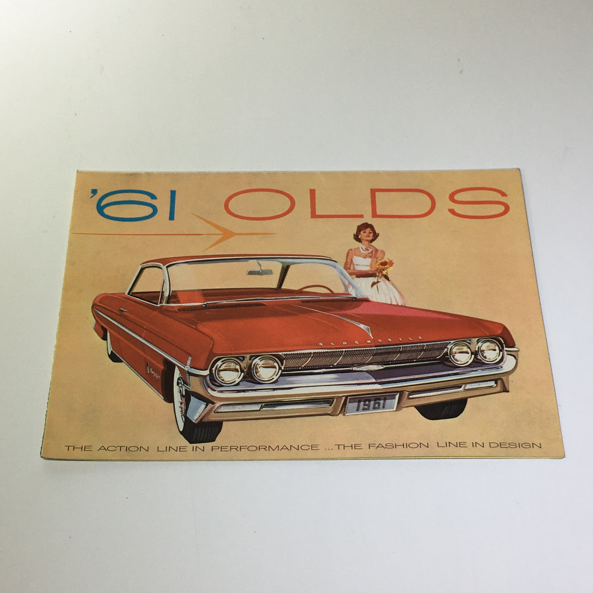 Front cover of the 1961 Oldsmobile Spirited Skyrocket Engine Hydra-Matic Drive Car Catalog Brochure showcasing the elegant design of the vehicle.