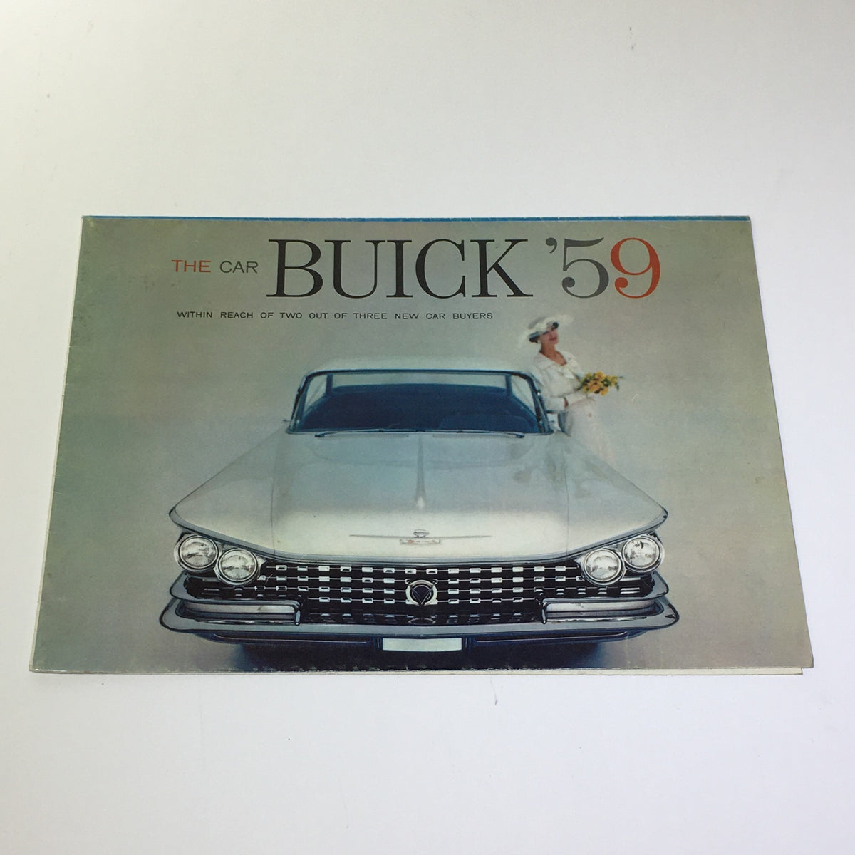 1959 Buick LeSabre Standard Twin Turbine Transmission 24-P Car Catalog Brochure featuring a frontal view of the Buick car with a woman holding flowers, showcasing vintage automotive design.