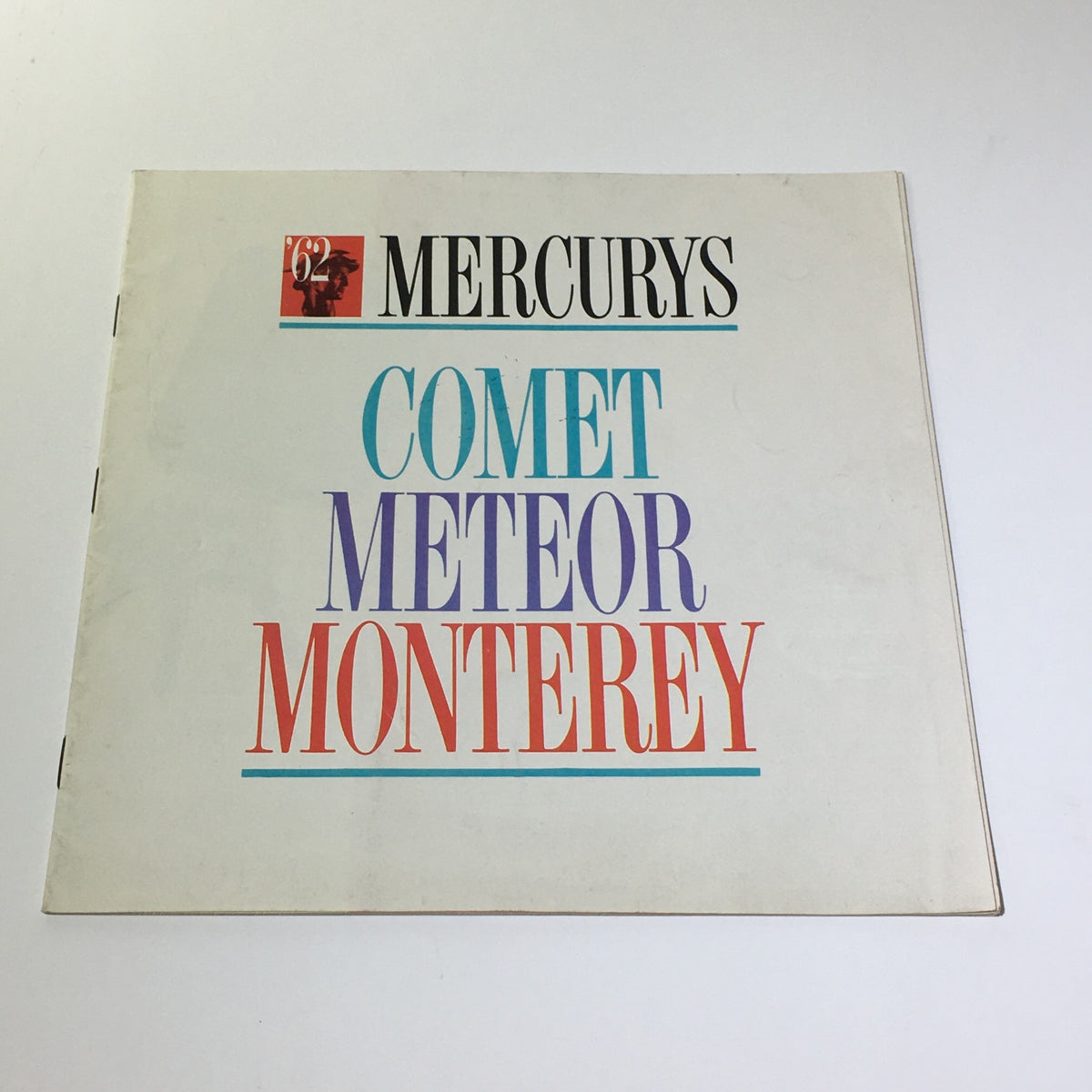 Cover of the 1962 Mercury's Comet Meteor Monterey V-8 Engine 2-Barrel Carburetor Car Catalog showcasing the title in colorful typography.