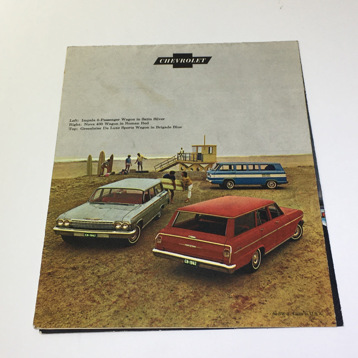 Back cover image of the 1962 Chevrolet Wagons Impala 6-Passenger Wagon Greenbrier De Luxe Sports Catalog featuring various Chevrolet wagon models in a beach setting.