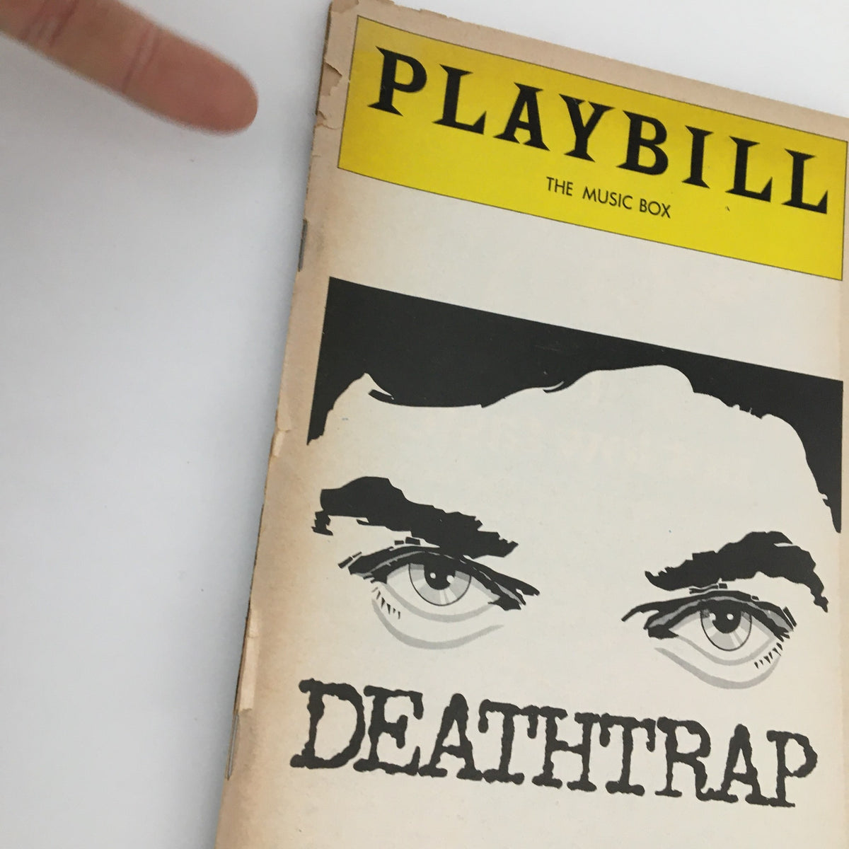 Close-up of the 1978 Playbill for 'Deathtrap' highlighting its cover design featuring dramatic eyes and the show's title.