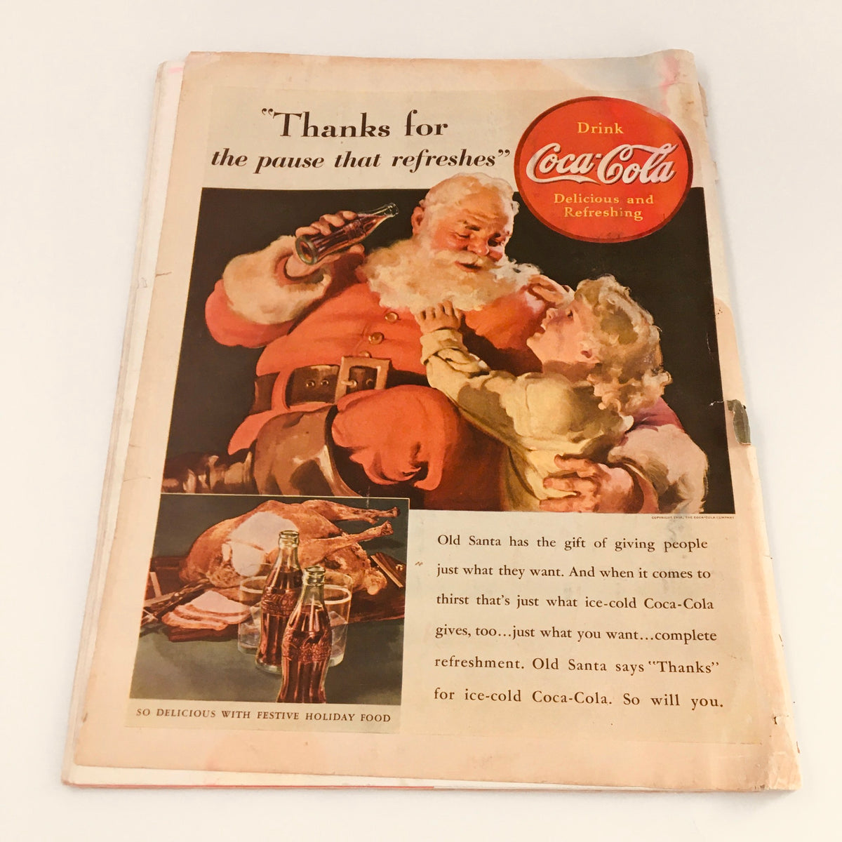 Back cover of the vintage Collier's Magazine from December 3, 1938, displaying a nostalgic Coca-Cola advertisement featuring Santa Claus. Captures the essence of vintage advertising.