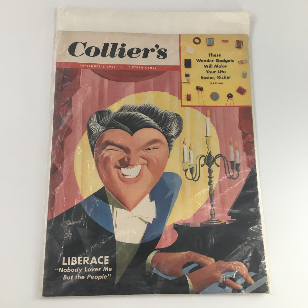 Collier's Magazine from September 3, 1954 in plastic cover, showcasing a colorful illustration of Liberace with the caption 'Nobody Loves Me But the People', highlighting its collectible value.