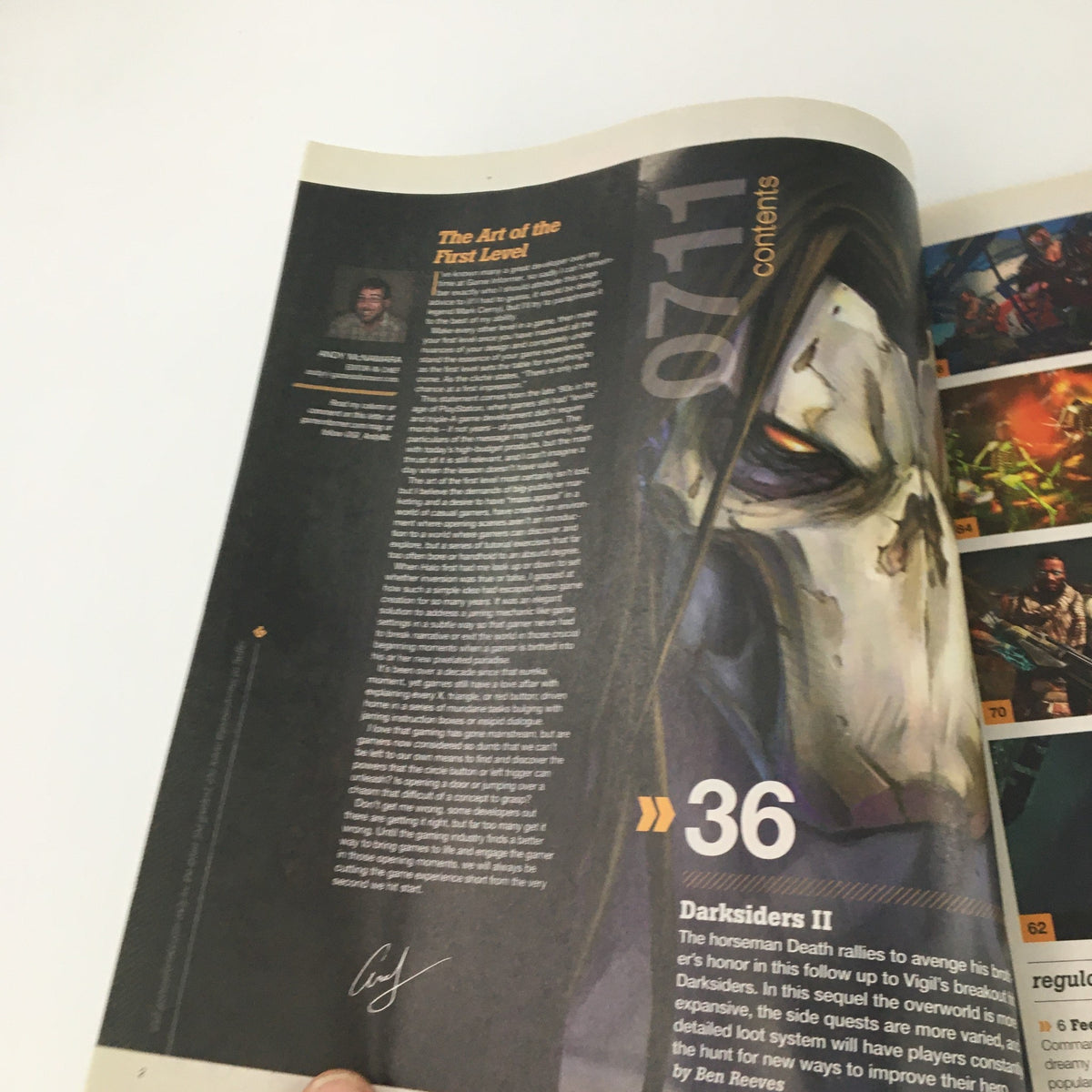 Contents page from Game Informer Magazine July 2011 Issue 219 discussing the Darksiders II video game, featuring artwork and insights about the first level of the game.