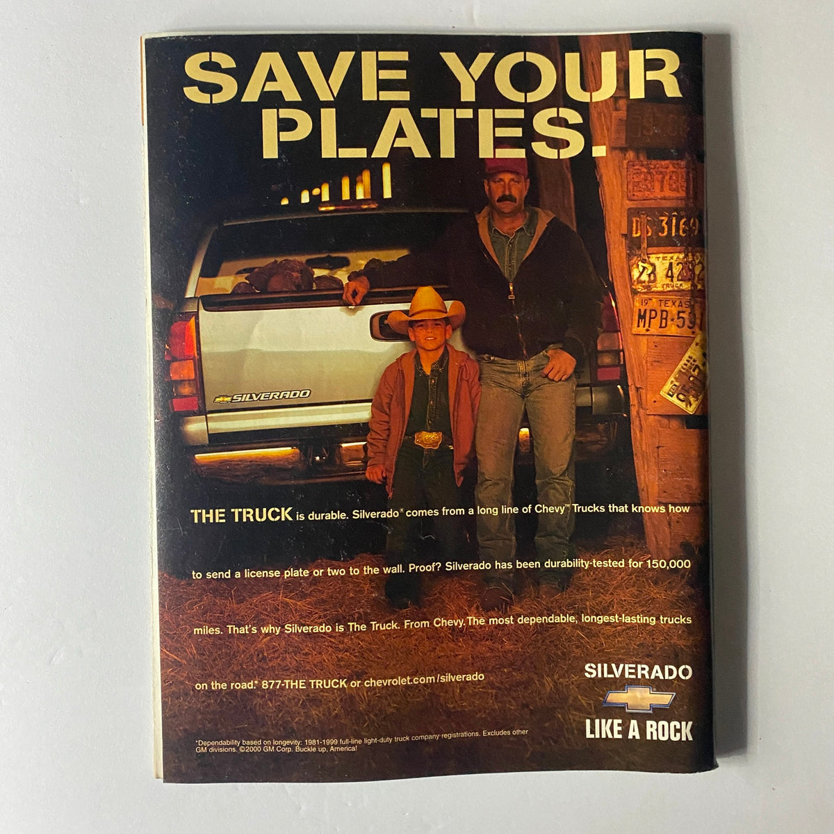 Back cover advertisement for Chevrolet Silverado, highlighting the durable truck design with a cowboy and a man standing beside the vehicle, emphasizing the compatibility for license plates.