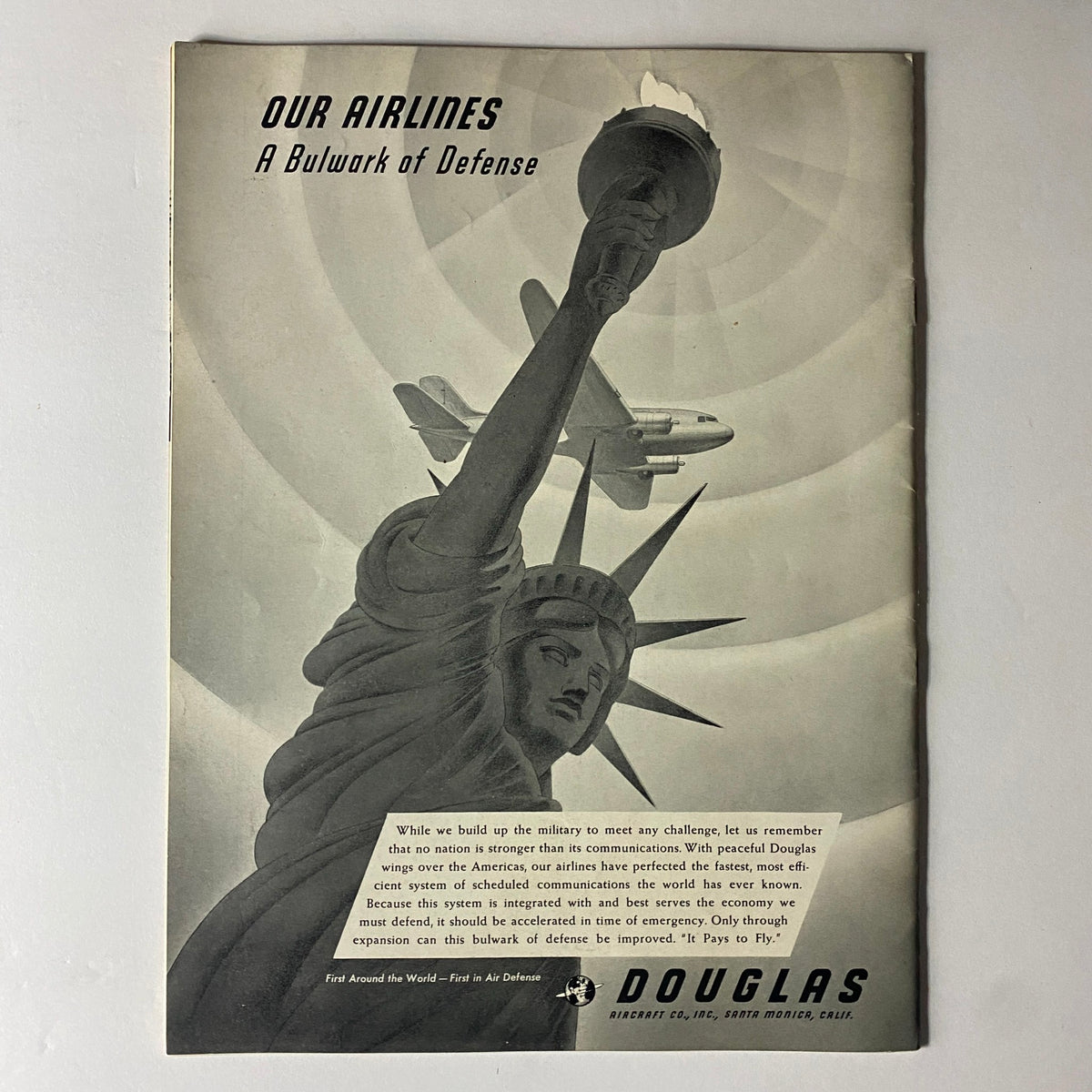 Back cover of Douglas Airview Magazine August 1940 showcasing the Statue of Liberty with an airplane and a message about airlines as a bulwark of defense.