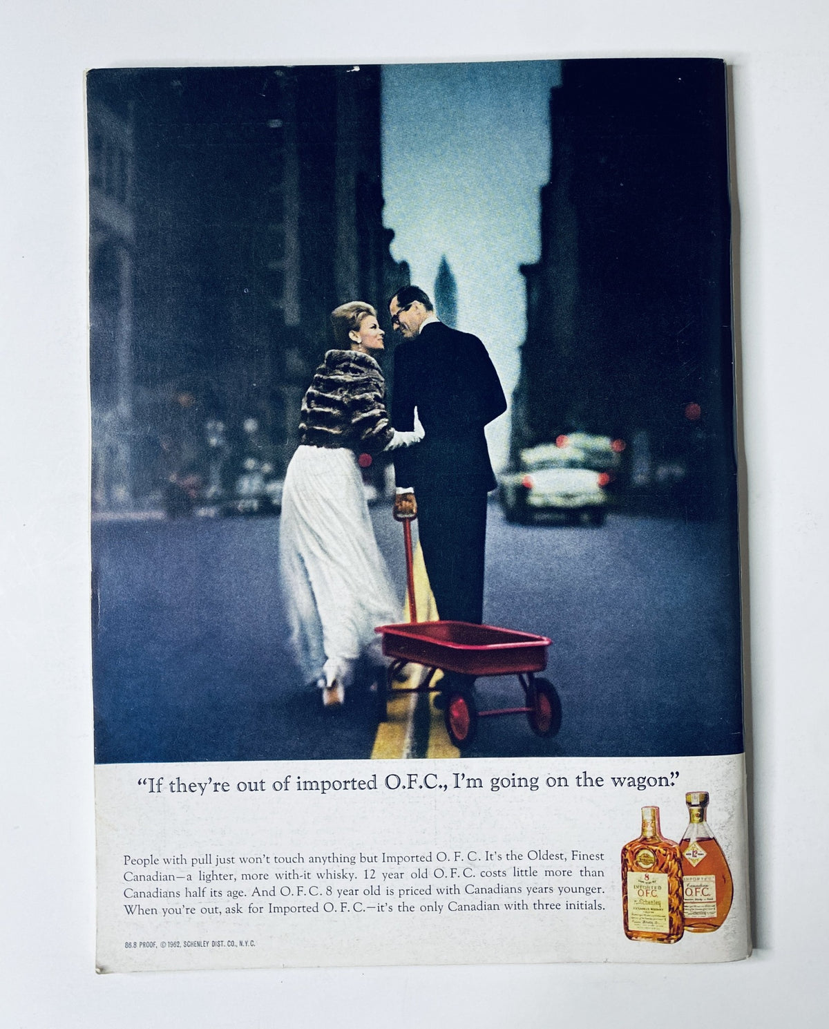 Back cover of The New Yorker Magazine June 6, 1964 displaying an advertisement for O.F.C. whiskey with a stylish couple, emphasizing luxury and sophistication in vintage design.