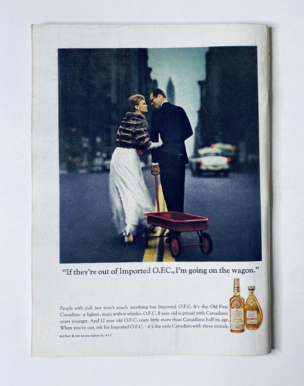 Vintage advertisement featuring a well-dressed couple, with a red wagon and a bottle of whiskey, illustrating the New Yorker Magazine September 26, 1964 Fruit Still Life Cover A. Birnbaum, in very good condition.