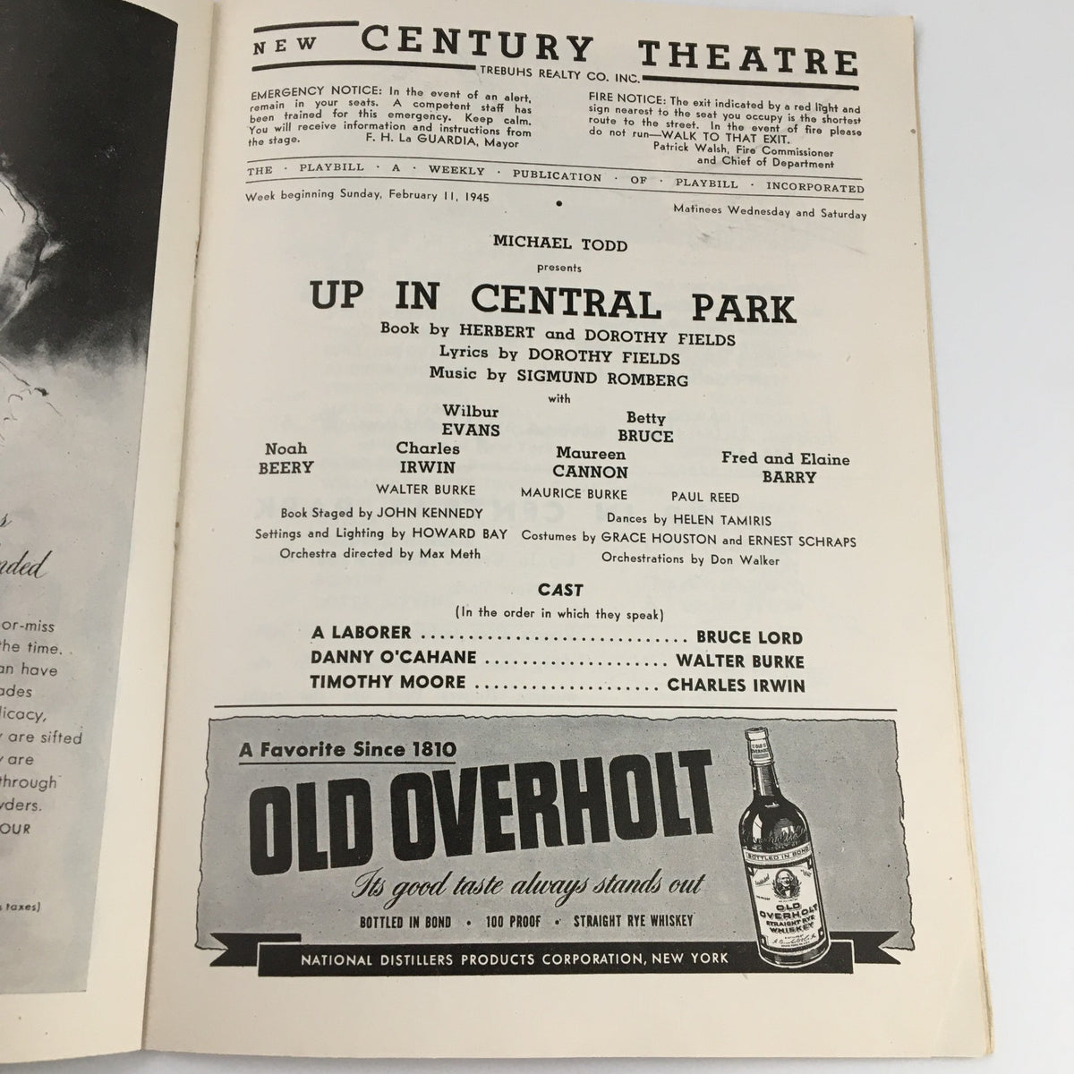 Interior page of the 1945 Playbill for 'Up In Central Park' at The New Century Theatre listing cast members and creative team details, highlighting Wilbur Evans and other performers.