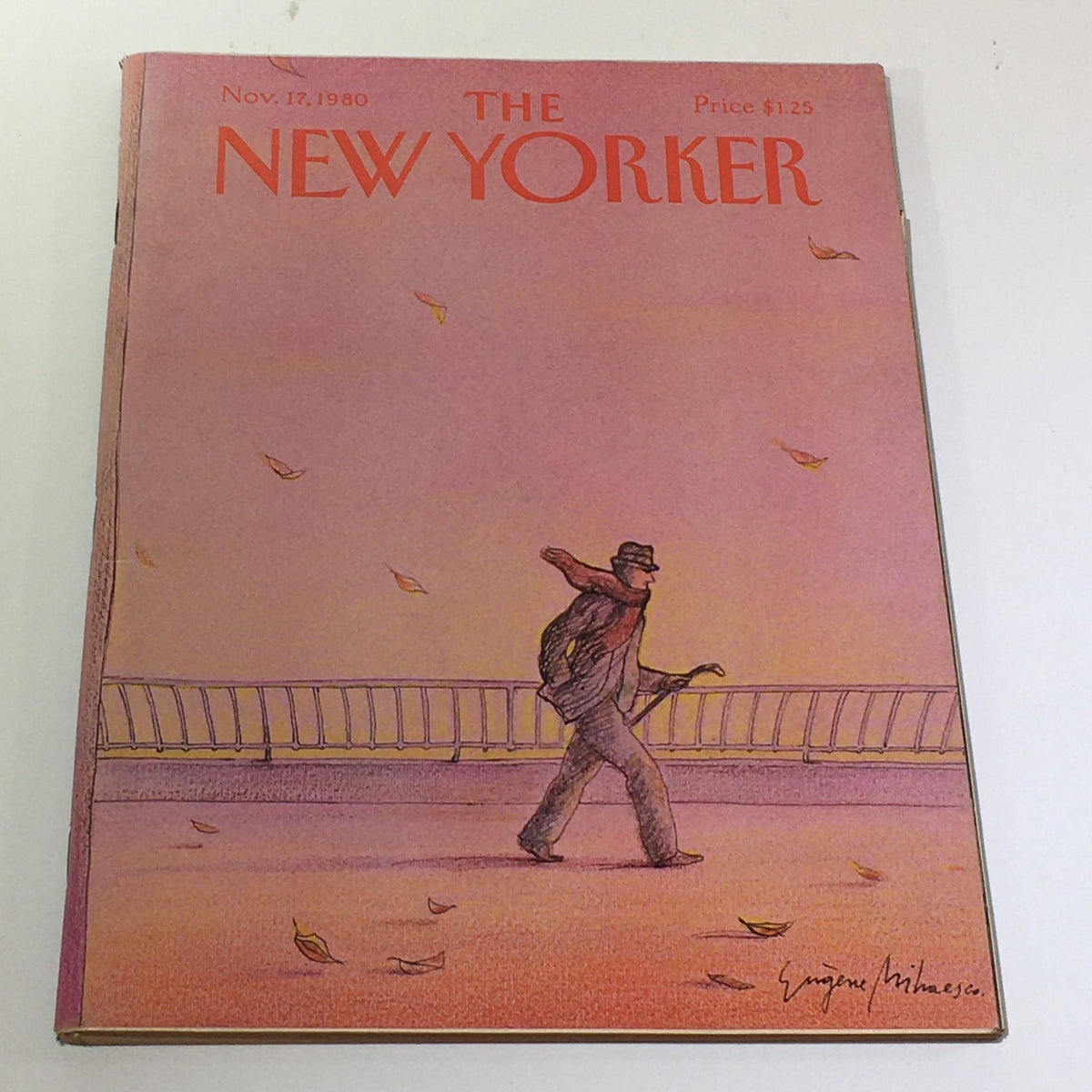 Cover of The New Yorker: November 17 1980 featuring a man walking with an umbrella, illustrated by Eugene Mihaesco, showcasing a calm autumn scene.