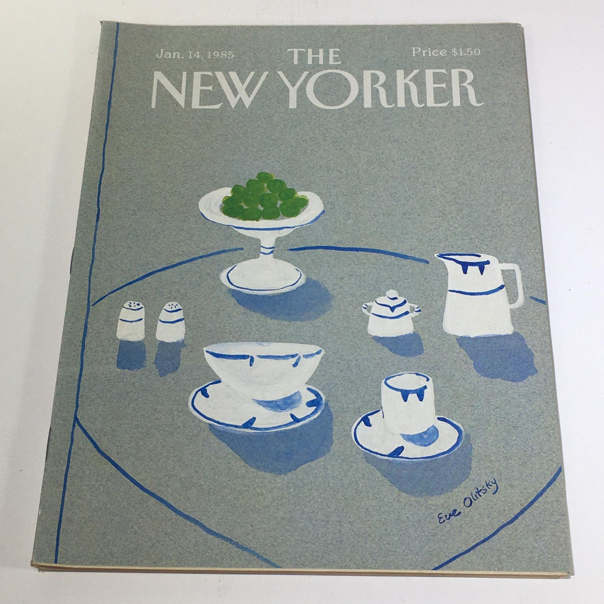Cover of The New Yorker magazine from January 14, 1985, featuring a theme cover illustration by Eve Olitsky. The design showcases a minimalist table setting with green fruit, white dishware, and blue accents, reflecting the artistic style of the time.