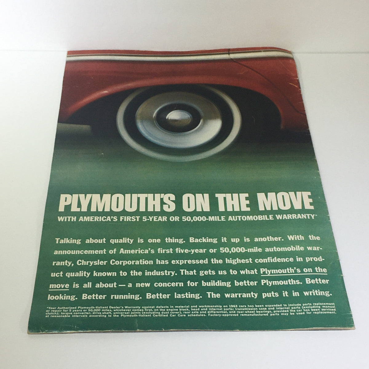 Back cover of the 1963 Plymouth by Chrysler Corp. brochure featuring a close-up of a wheel with promotional text about the vehicle's quality and warranty.