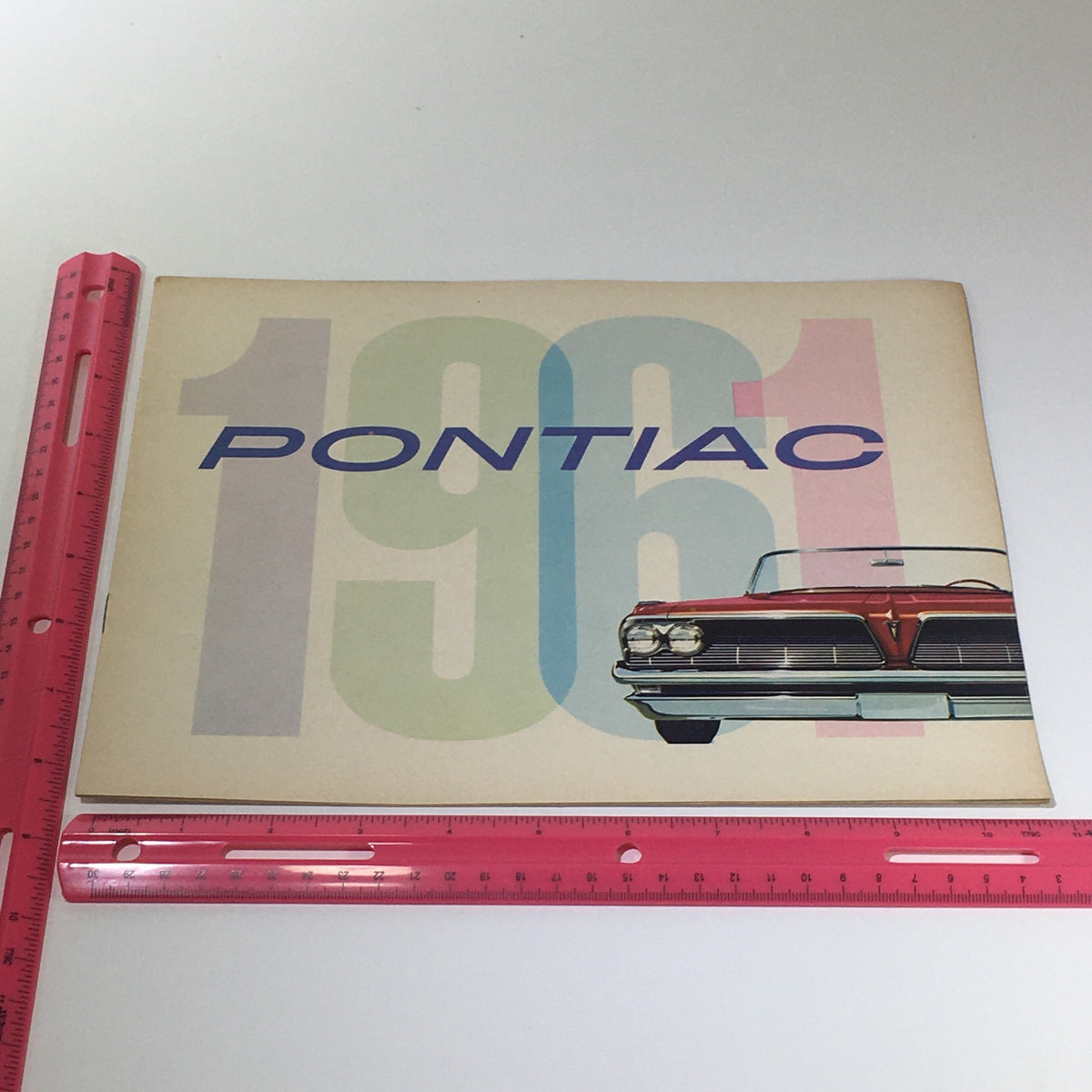 Cover of the Pontiac 1961 Catalina 6 to 9-Passenger Safari Wide-Track Car Catalog Brochure featuring a classic car illustration and 1961 lettering, highlighting its vintage design and automotive heritage.