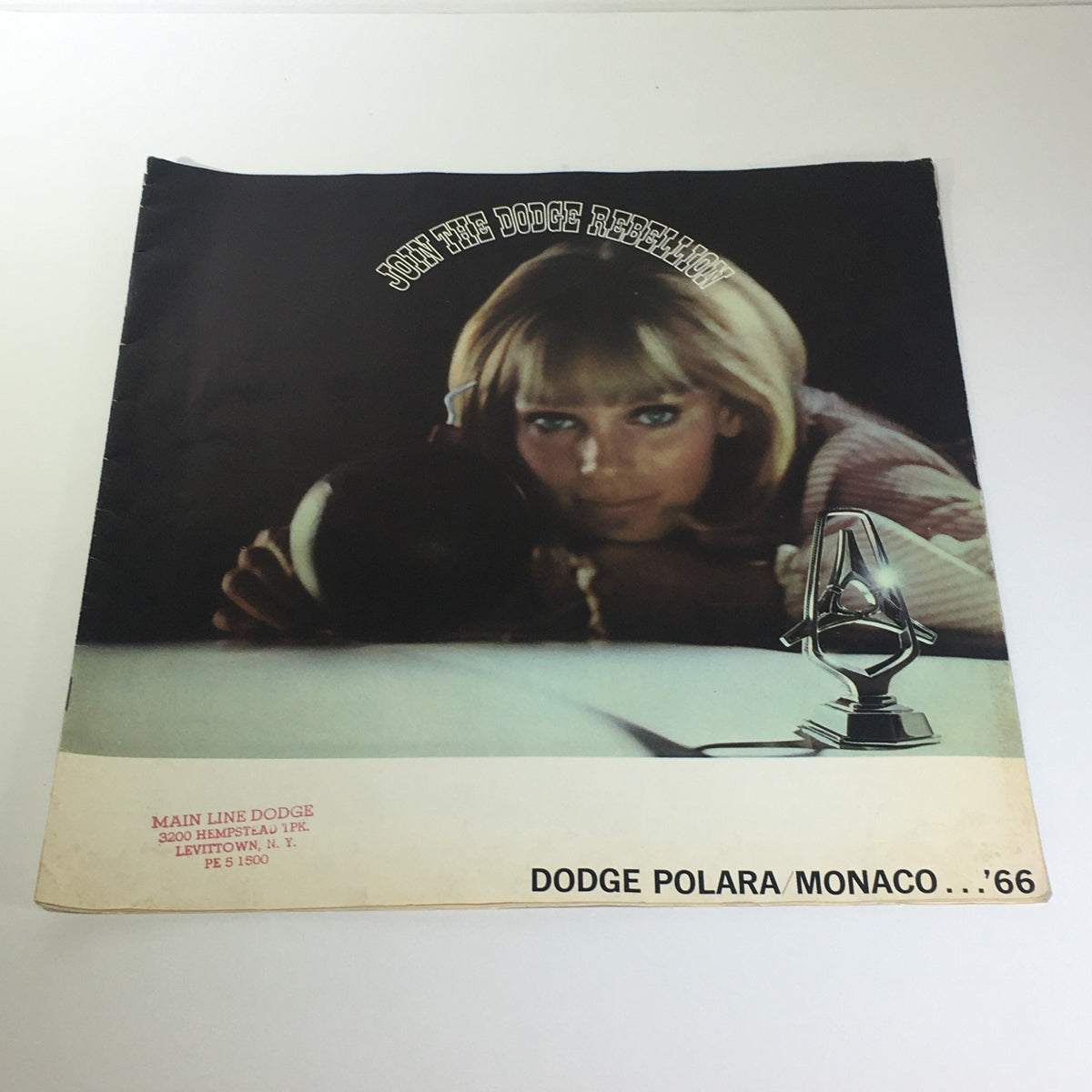 1966 Dodge Polara Monaco by Chrysler 2-Door Convertible Car Catalog Brochure cover featuring a model holding a bowling ball in a dramatic pose.