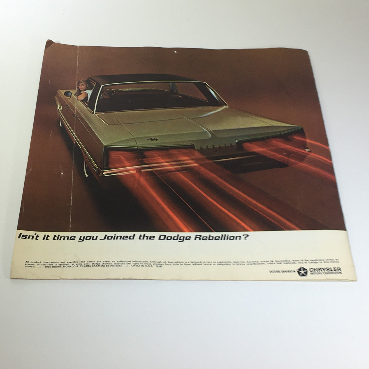1966 Dodge Polara Monaco by Chrysler 2-Door Convertible Car Catalog Brochure back cover with an elegant car in motion and a model inside, promoting the Dodge Rebellion.