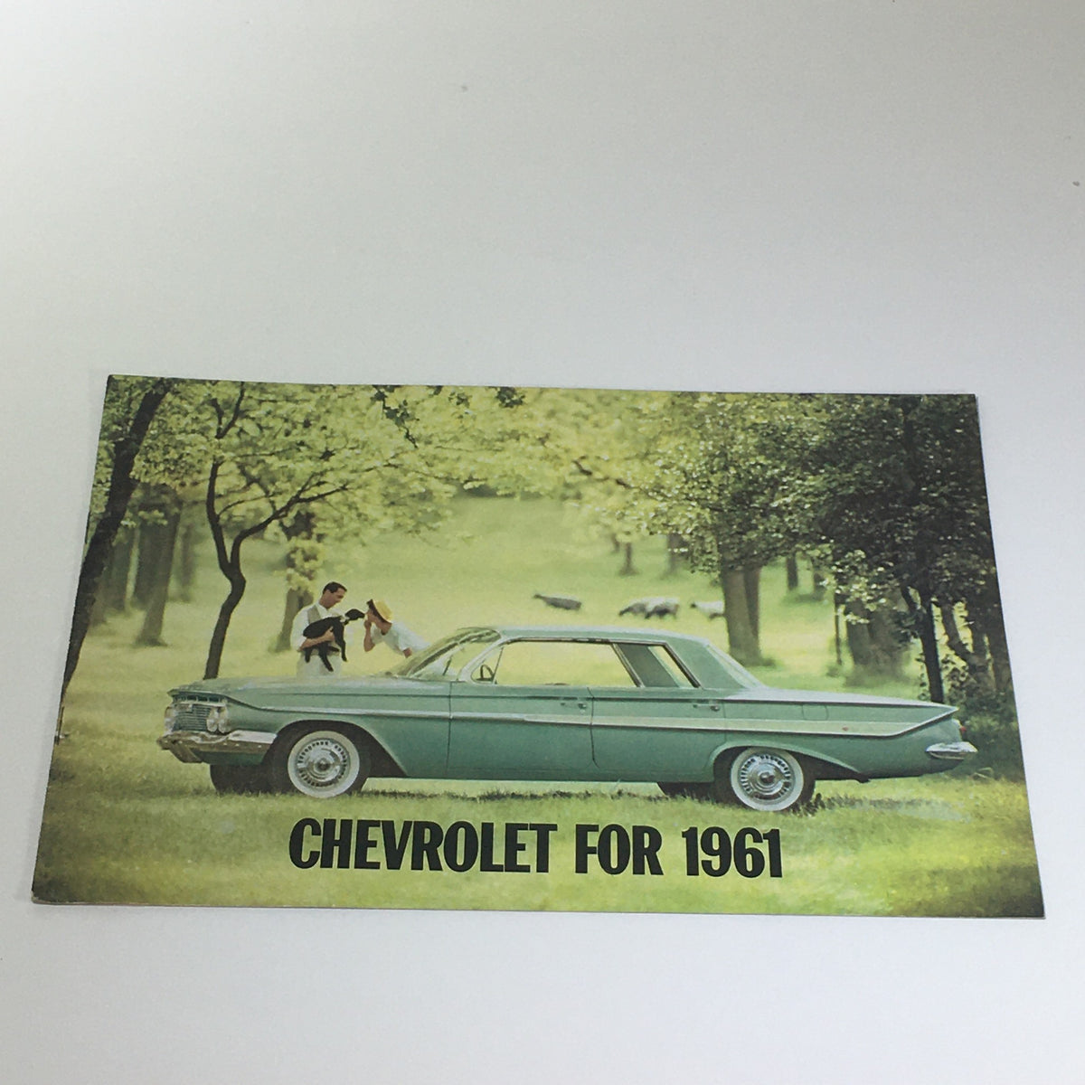Chevrolet for 1961 Bel Air Series Sport Coupe 4-Door Sedan Car Catalog Brochure featuring a classic car parked in a scenic setting with children playing.