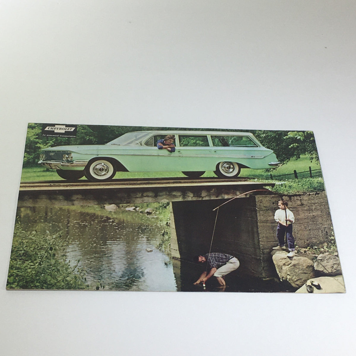 Chevrolet for 1961 Bel Air Series Sport Coupe 4-Door Sedan Car Catalog Brochure showing a family with a green station wagon near a creek.