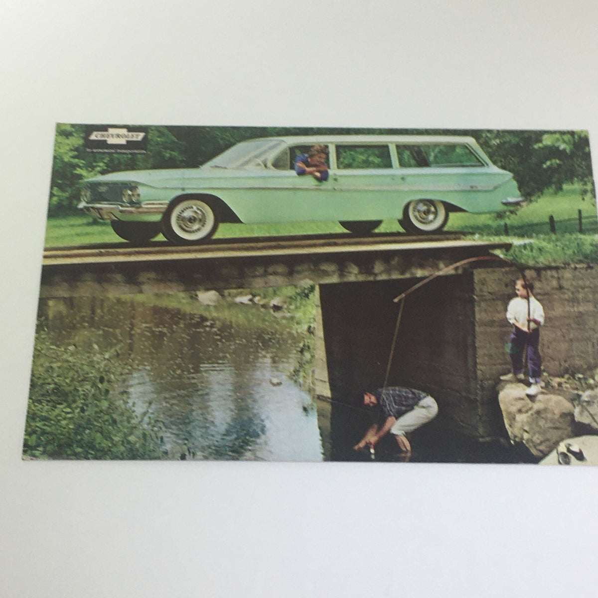 Chevrolet for 1961 Impala Series brochure featuring a light green wagon parked on a bridge with children and a fisherman.