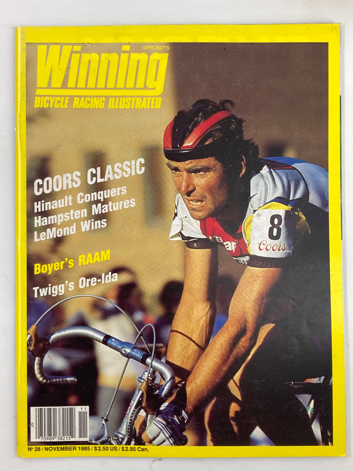 Cover of Winning Bicycle Racing Illustrated November 1985, featuring Bernard Hinault in a cycling race. The magazine highlights the Coors Classic, showcasing Hinault's competitive success and key events in cycling history.