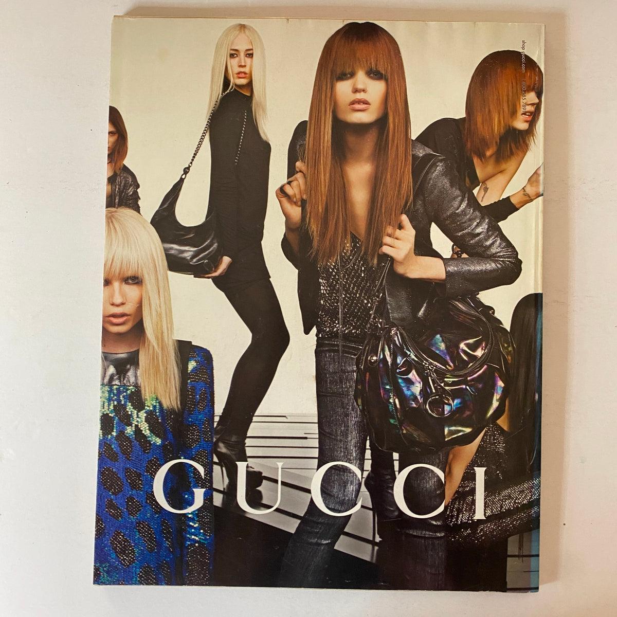Cover page of W Magazine October 2009 highlighting a Gucci fashion look, featuring models styled with modern hairstyles and fashionable purses, emphasizing the vibrant aesthetic of the era.