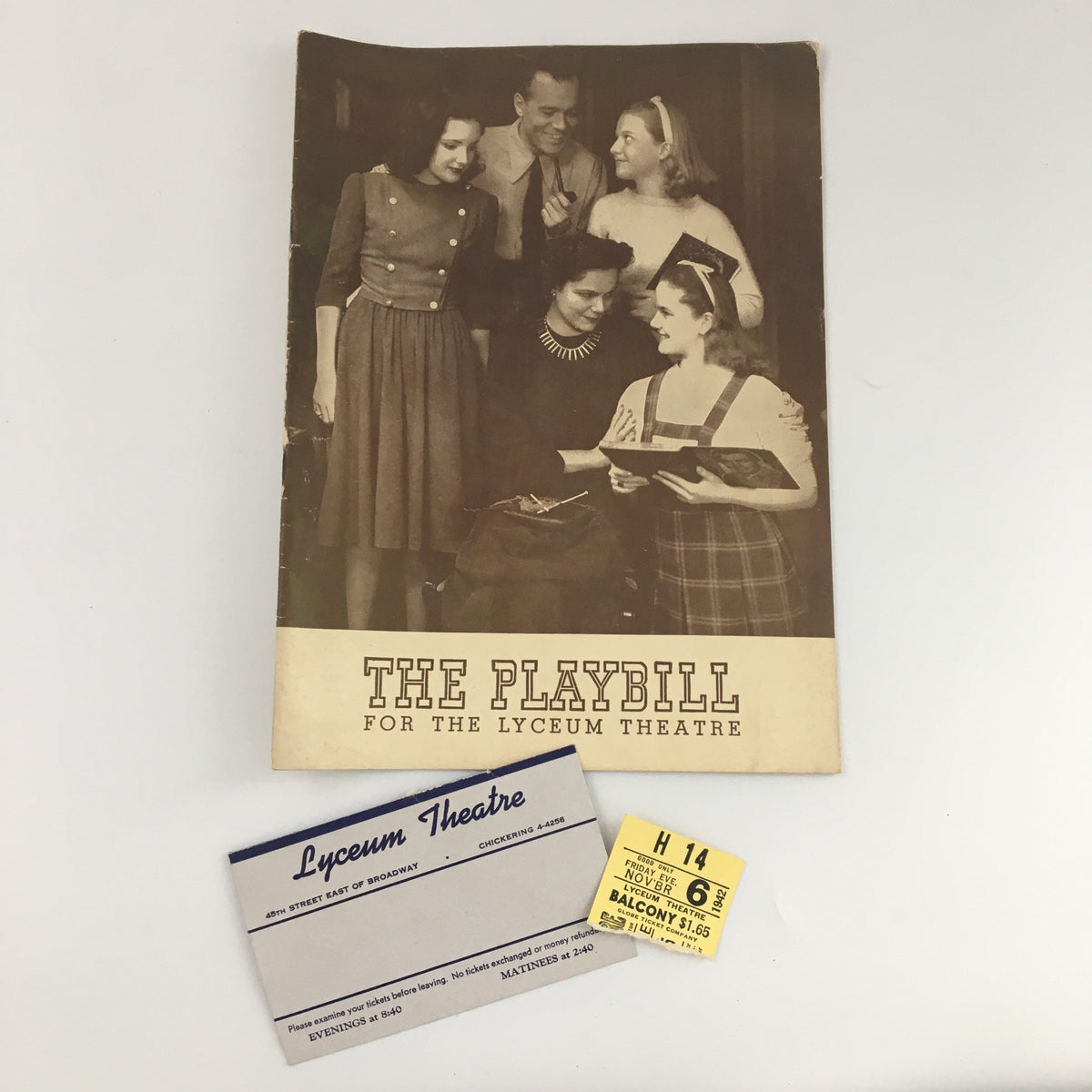 1942 Playbill for the Lyceum Theatre along with original tickets for 'Junior Miss', displayed with the playbill in a vintage-style setting.