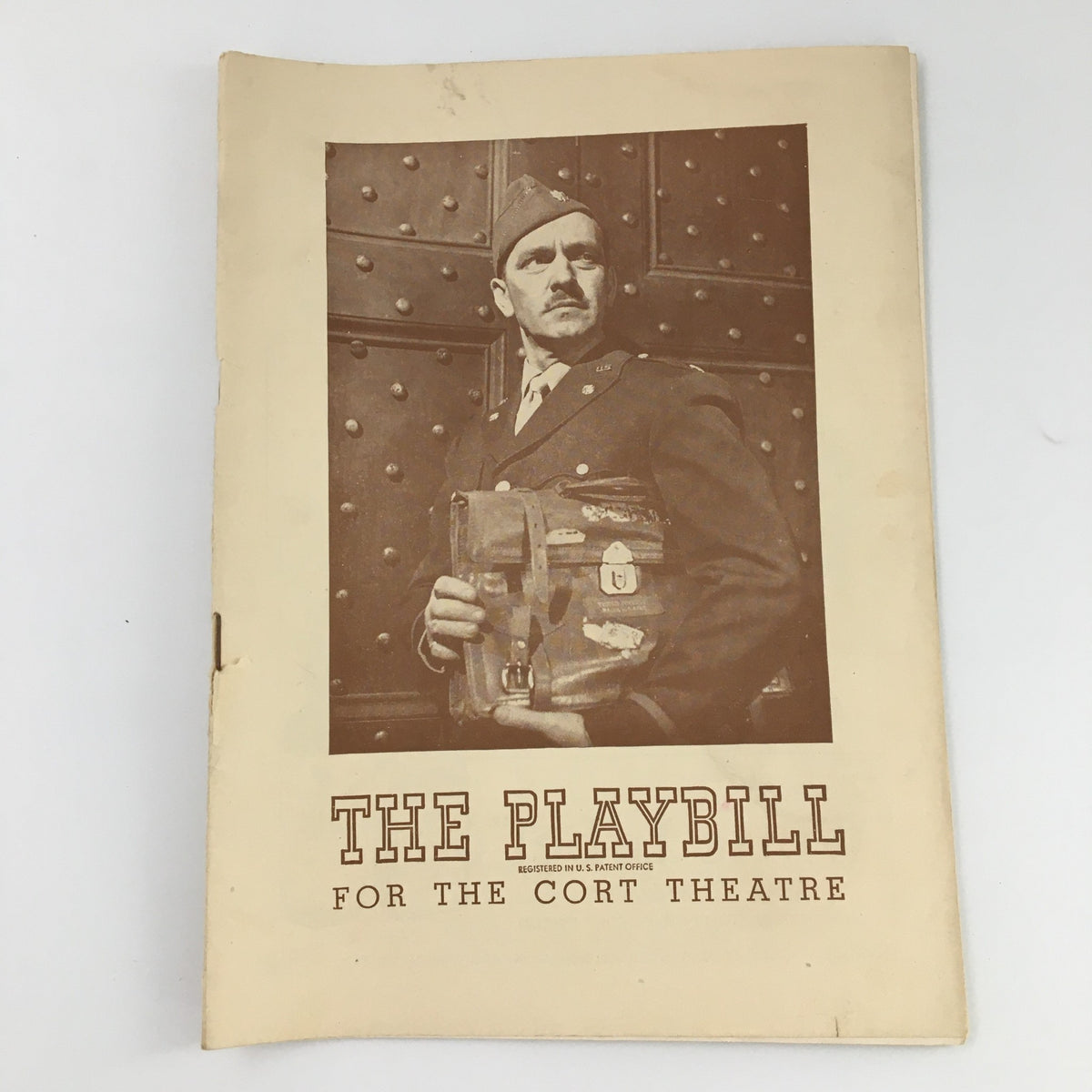 1945 Playbill for 'A Bell For Adano' at Cort Theatre featuring a vintage photograph of a soldier holding a satchel.