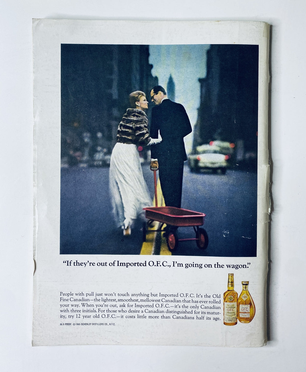 Vintage advertisement from The New Yorker Magazine May 1, 1965, promoting Imported O.F.C. whiskey, featuring a couple in formal attire on a city street.