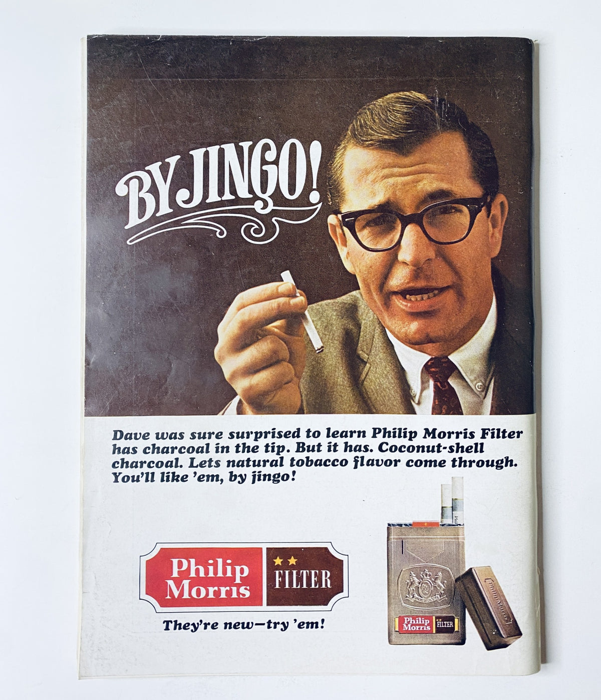 Advertisement from The New Yorker Magazine April 17, 1965 for Philip Morris Filter cigarettes, showcasing a man holding a cigarette and emphasizing the product's unique charcoal filter.