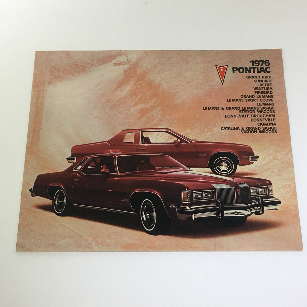 Vintage 1976 Pontiac Station Wagons 2-Door Hatchback Coupe Car Brochure Catalog featuring a striking red Pontiac vehicle showcased on the cover.